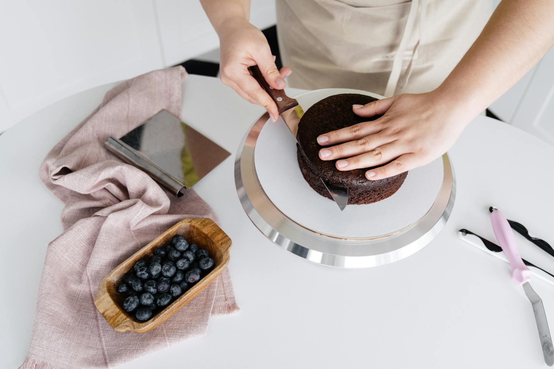 crop cook cutting cake on table